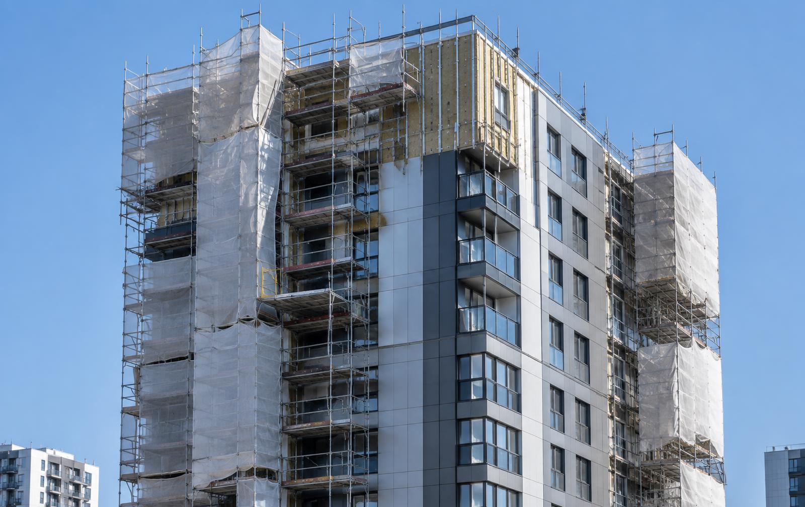Illustrative residential tower undergoing cladding replacement behind scaffolding